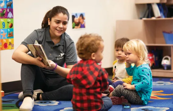 teacher with young kids in early learning